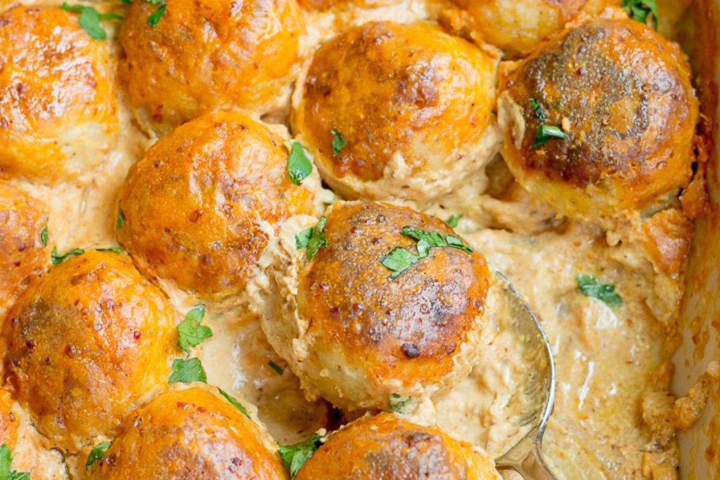 Mustard chicken meatballs in a pan.