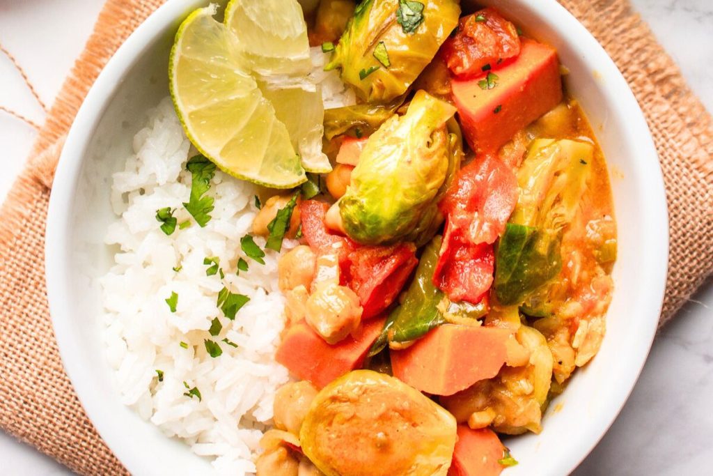Vegan curry with rice in a white bowl.