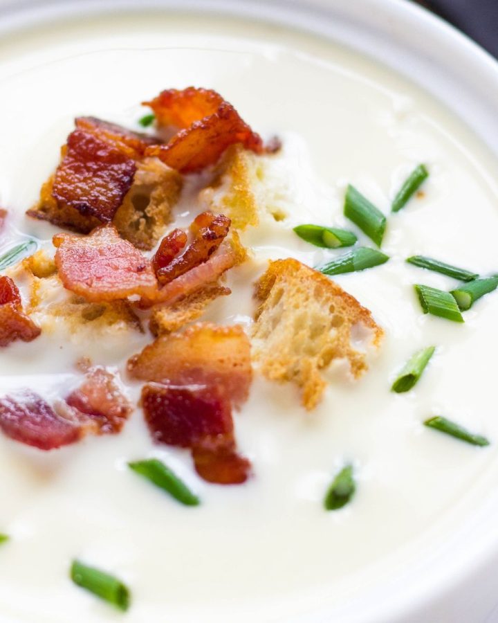 Parmesan soup in a white bowl.